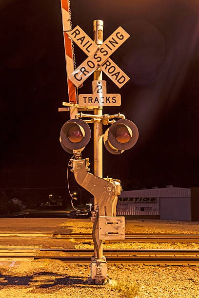 Railroad crossing by night with sign in kingman