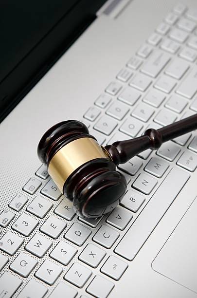 Gavel on laptop keyboard: online justice.