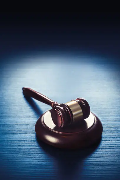 high contrast image of Judge gavel on a blue wooden background